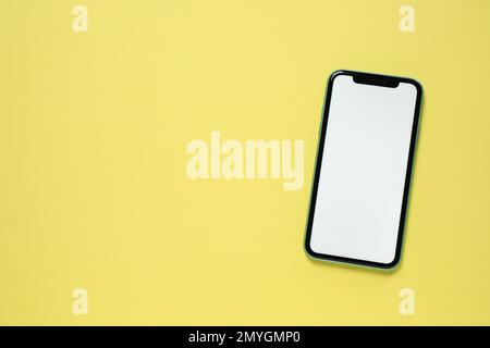 MYKOLAIV, UKRAINE - JULY 07, 2020: iPhone 11 on yellow background, top view. Mockup for design Stock Photo