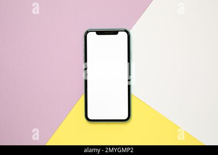 MYKOLAIV, UKRAINE - JULY 07, 2020: iPhone 11 on color background, top view. Mockup for design Stock Photo