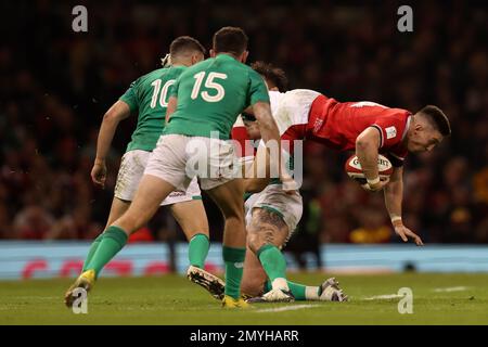 Cardiff, UK. 04th Feb, 2023. Josh Adams of Wales is tackled. Guinness Six Nations championship 2023 match, Wales v Ireland at the Principality Stadium in Cardiff on Saturday 4th February 2023. pic by Andrew Orchard/Andrew Orchard sports photography/ Alamy Live News Credit: Andrew Orchard sports photography/Alamy Live News Stock Photo