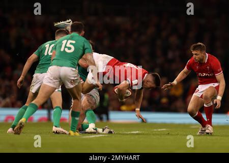 Cardiff, UK. 04th Feb, 2023. Josh Adams of Wales is tackled. Guinness Six Nations championship 2023 match, Wales v Ireland at the Principality Stadium in Cardiff on Saturday 4th February 2023. pic by Andrew Orchard/Andrew Orchard sports photography/ Alamy Live News Credit: Andrew Orchard sports photography/Alamy Live News Stock Photo