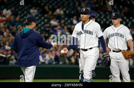 Seattle Mariners' Charlie Furbush, left, points out new socks as