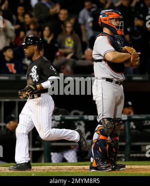 Chicago White Sox's Jimmy Rollins, front, throws his bat after