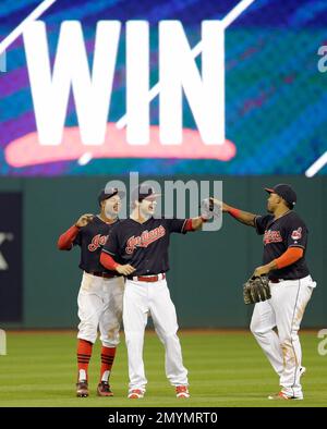 Cleveland Indians Francisco Lindor (L) and Rajai Davis leap to