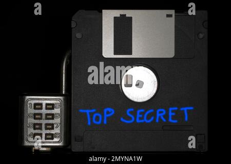 Floppy disc with combination lock with the blue inscription Top Secret, black background Stock Photo