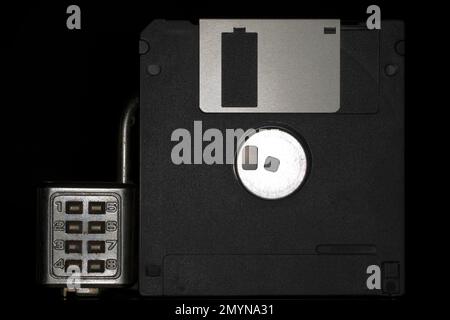 Floppy disc with combination lock, black background Stock Photo
