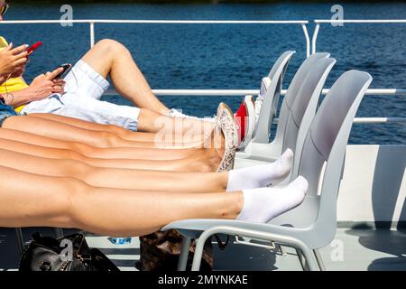 Legs of a group of teenagers on the upper deck of an excursion steamer, Potsdam, Brandenburg Stock Photo