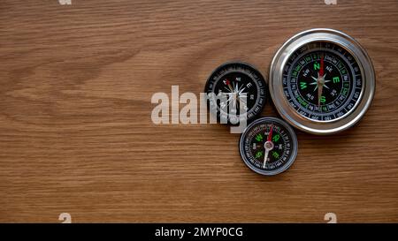 Compass on a wooden background with copy space. Stock Photo