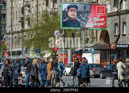 People walk past the poster with WWII Soviet dictator Josef Stalin which was sponsored by local branch of the Communist Party celebrating Victory Day in Novosibirsk, Russia, Thursday, May 5, 2016, about 2800 kms (1,750 miles) east of Moscow. Russia celebrates victory in WWII on May 9. (AP Photo/Ilnar Salakhiev)