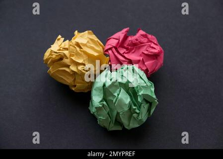 A colorful crumpled paper balls on a black background. Stock Photo