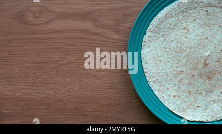 Wholegrain wraps on a green plate. Stock Photo