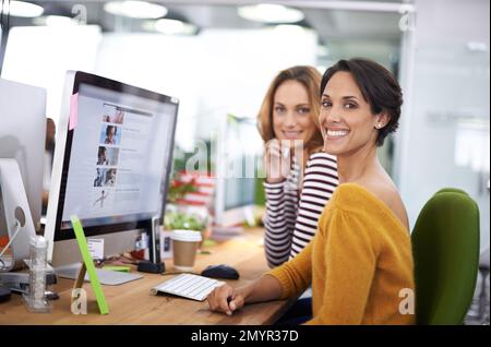 Lets get creative. Cropped view of two young designers working on computers. Stock Photo