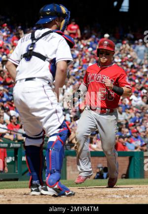 Texas Rangers right fielder Kole Calhoun throws during the second inning of  a spring training baseball game against the Seattle Mariners Monday, March  28, 2022, in Peoria, Ariz. (AP Photo/Charlie Riedel Stock