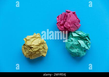 A colorful crumpled paper balls on a blue background. Stock Photo