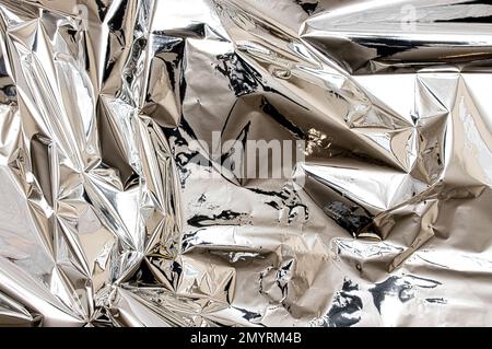 Shiny silver foil close-up. Abstract background, glossy surface Stock Photo