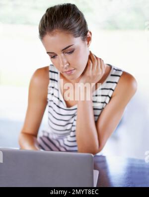 So many distractions online. Gorgeous young woman using a laptop. Stock Photo