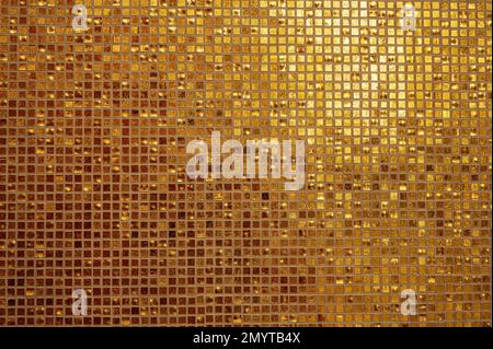 Small gold tile texture. Small golden tiles arranged to fit it into background. Golden tiled glasses mosaic background Stock Photo