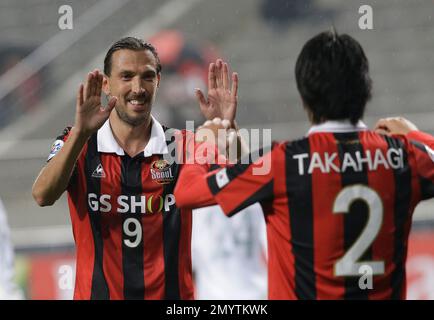 Dejan Damjanovic of South Korea's FC Seoul, left, shoots against