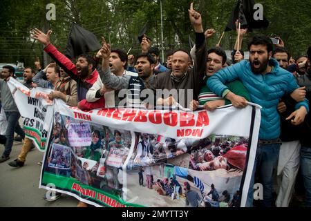 Engineer Rashid Ahmed, fourth from right, an independent member of the Jammu and Kashmir state assembly and head of Awami Itihaad party (AIP), along with his supporters shout slogans against Indian army during a protest against the recent deaths of civilians allegedly fired upon by Indian security forces during protests, in Srinagar, Indian controlled Kashmir, Tuesday, April 19, 2016. Indian police detained dozens of activists of AIP during a protest who were demanding punishment for those responsible for the deaths of civilians allegedly fired upon by Indian security forces on April 12, 2016.