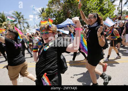 Participants march during a parade along Ocean Drive at Miami Beach Gay Pride, Sunday, April 10, 2016, in Miami Beach, Fla. The annual event is in its eighth year, and is meant to bring together members of the LGBT community, along with friends, families, and their supporters. (AP Photo/Lynne Sladky)
