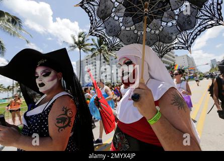 Participants march during a parade along Ocean Drive at Miami Beach Gay Pride, Sunday, April 10, 2016, in Miami Beach, Fla. The annual event is in its eighth year, and is meant to bring together members of the LGBT community, along with friends, families, and their supporters. (AP Photo/Lynne Sladky)