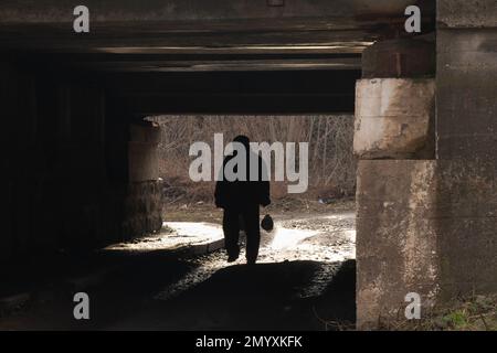 silhouette of a man passing under a railway bridge Stock Photo - Alamy