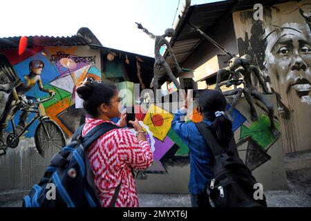 Kolkata, India. 04th Feb, 2023. Visitors take photos of beautiful wall graffiti during an open air Art Fest. Kolkata streets and different slums seen getting painted with colorful graffitis as an initiative of an ongoing Art Fest (Behala Art Fest). Artists from different art colleges have participated to make the city more beautiful. Credit: SOPA Images Limited/Alamy Live News Stock Photo