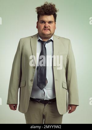 How do I look. Studio shot of an overweight man wearing badly fitting clothing. Stock Photo