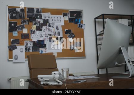 Modern detective office with computer and board Stock Photo - Alamy