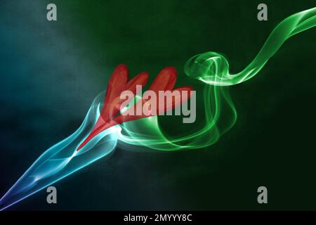 Two red hearts and smoke in various colors against the dark green and blue background Stock Photo