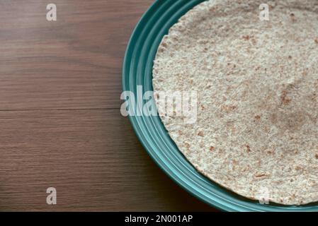 Wholegrain wraps on a green plate. Stock Photo