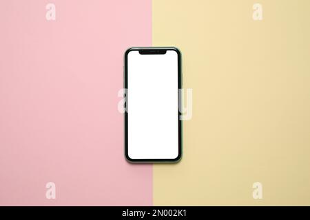 MYKOLAIV, UKRAINE - JULY 07, 2020: iPhone 11 on color background, top view. Mockup for design Stock Photo