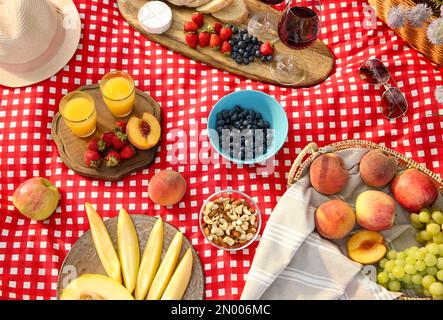 Delicious food and drinks on picnic blanket, above view Stock Photo