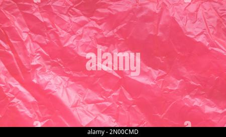 Red and crumpled plastic bag background and texture. Stock Photo