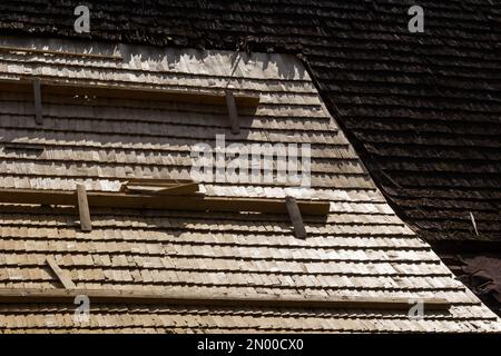 Roof construction site. Removal of old roof, replacement with new shingles, equipment and repair. Roofs are a very important part of all housing proje Stock Photo