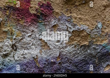 Brick wall with multi-colored paint close-up. Background brick creative. Stock Photo
