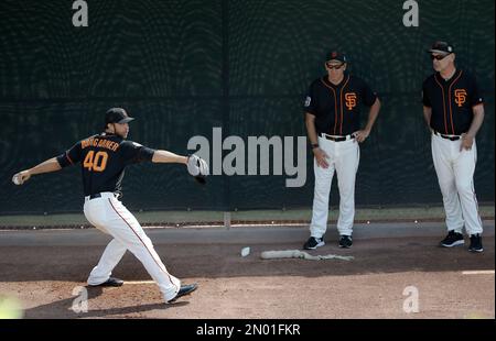 Former Oakland Athletics player Dave Stewart throws out the ceremonial  first pitch before a baseball game between the Athletics and the San  Francisco Giants in Oakland, Calif., Sunday, Aug. 25, 2019. (AP