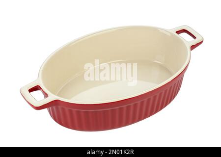 Red ceramic baking dish on a white background. Empty oval baking dish for gratin. File contains clipping path. Stock Photo