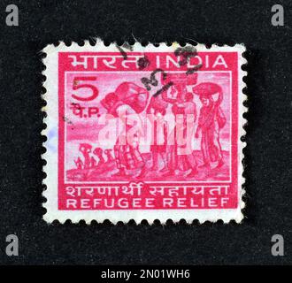 Cancelled postage stamp printed by India, that shows Refugees, Obligatory postal tax for Refugee Relief, circa 1971. Stock Photo