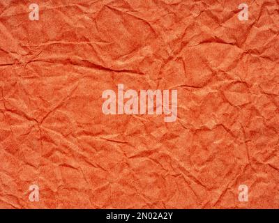 Orange crumpled matte paper texture. Blank page pattern for winter season Christmas festival card, new year designs decoration, background concepts Stock Photo