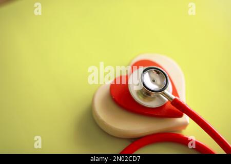 Doctor at his desk in the clinic's office. Stethoscope, test tubes, laptop, prescriptions, glasses on table. Stock Photo