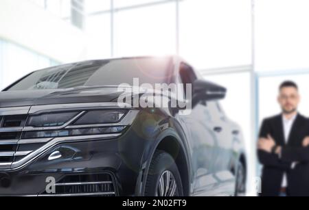 Customer choosing and buying car in dealership, focus on new auto Stock Photo