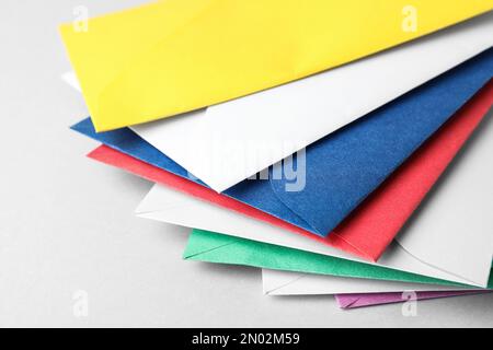 Colorful paper envelopes on light background, closeup Stock Photo