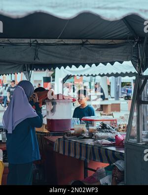 Pahang, Malaysia - Sep 23, 2022 Drinking stall food vendor selling local snacks. Stock Photo