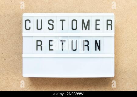 Lightbox with word customer return on wood background Stock Photo