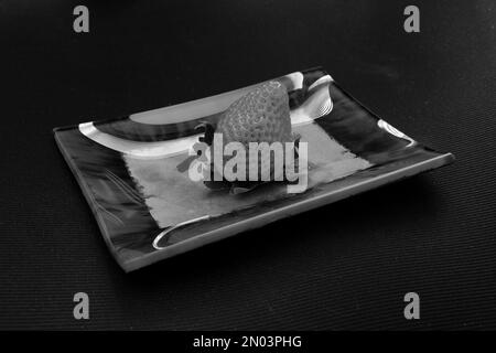 strawberry and artistic ashtray in monochrome Stock Photo