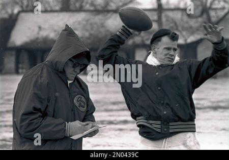 FILE - This Jan. 18, 1947, file photo shows Chicago Bears owner and coach  George Halas, left, watching as Bob Fenimore signs a contract with the Bears.  Halas left the Bears in