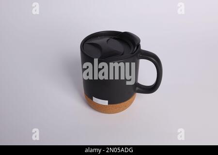 Black color coffee mug mock up , coffee mug with wooden bottom isolated white background Stock Photo