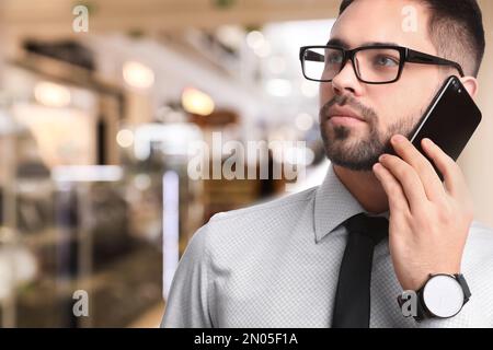 Wholesale and logistics concept. Manager talking on phone in store Stock Photo
