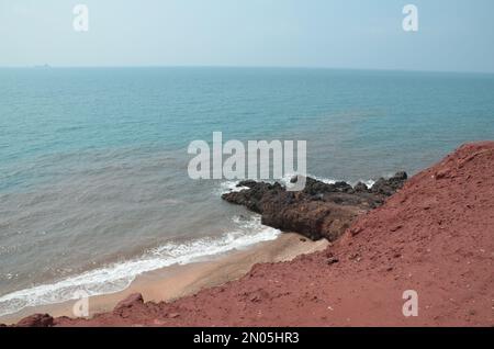 view from red mountains to the red beach and red colored sea of the persian gulf, Hormuz island Stock Photo