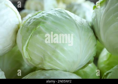 Pile of ripe white cabbages as background, closeup Stock Photo